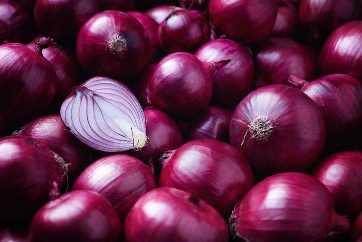 Full Frame Shot Of Purple Onions. Fresh whole purple onions and one sliced onion.