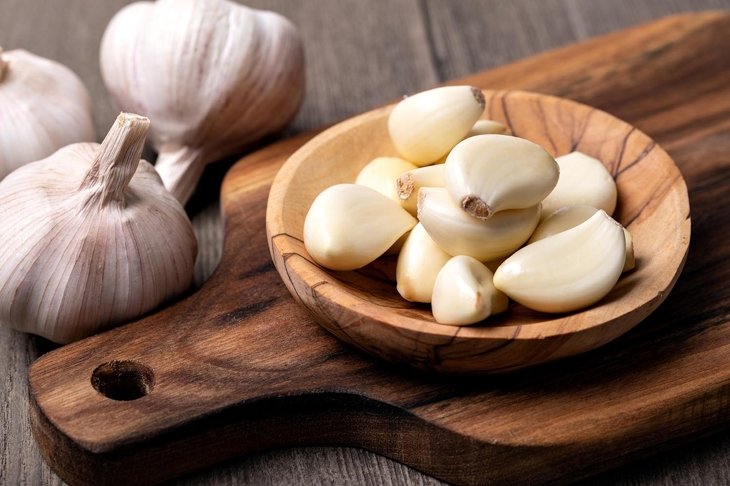 Garlic Cloves and Bulb in vintage wooden bowl